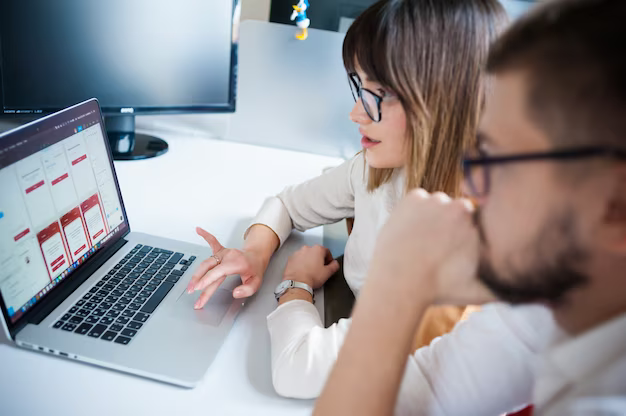 Young employees with laptop in office