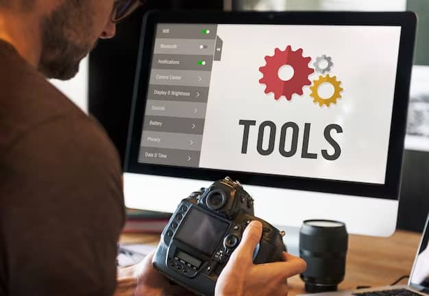 A man sits in front of a computer with tools written on it