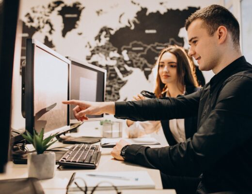 Workers at an it company working on a computer